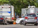 Police investigators work the scene of a homicide after a home invasion on Place du Comoran in Laval, north of Montreal Tuesday May 24, 2022.