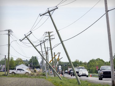 Leaning hydro poles after Saturday's storm in Ste-Anne-des-Plaines north of Montreal Tuesday May 24, 2022.