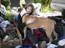 Alexandre Poulin hugs his dog Mowglie in a makeshift encampment in Montreal's east end on Wednesday May 25, 2022.