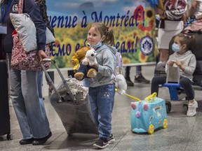 It was a long trip': Hope and tears as 305 Ukrainian refugees land in  Montreal | Montreal Gazette