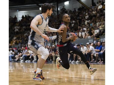 Hernst Laroche of  the Montreal Alliance drives for the basket against Danilo Djuricic of Scarborough Shooting Stars at the Verdun Auditorium on Sunday, May 29, 2022.