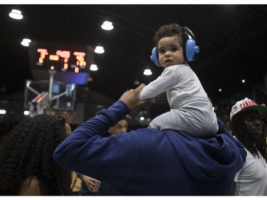 Zyon Paul sits on his father Kasey Paul's shoulders while watching the Montreal Alliance and the Scarborough Shooting Stars at the Verdun Auditorium on Sunday, May 29, 2022.
