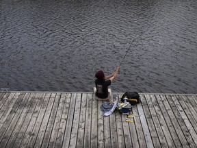 A man casts a line in to the Lachine Canal May 30, 2022.