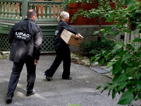 "We can't have a full trust in this institution," says Liberal Leader Dominique Anglade. Above: UPAC investigators raid the home of former Montreal mayor Gérald Tremblay in 2015.