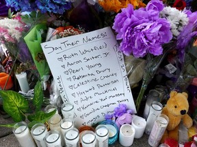 The names of the ten people killed in Saturday's shooting at Tops market are part of a makeshift memorial across the street from the store on May 17, 2022 in Buffalo, New York. A gunman opened fire at the store killing ten people and wounding another three.