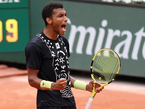 Montreal's Félix Auger-Aliassime celebrates during his French Open first round match against Peru's Juan Pablo Varillas at Roland Garros in Paris.