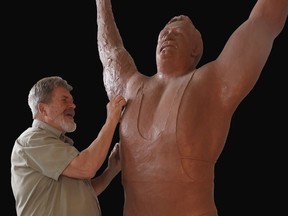 Artist Norm Williams works on his sculpture of Doug Hepburn, who was the world's strongest man in 1954.