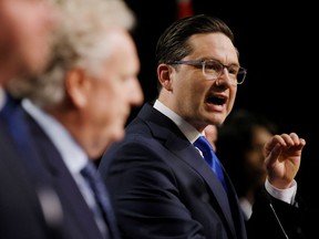 Pierre Poilievre spars with Jean Charest at the Conservative leadership debate on May 5, 2022.