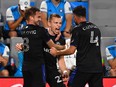 CF Montréal defender Alistair Johnston (22) celebrates with midfielder Djordje Mihailovic (8) and defender Rudy Camacho (4) after scoring a goal in the second half at Bank of America Stadium on May 14, 2022.