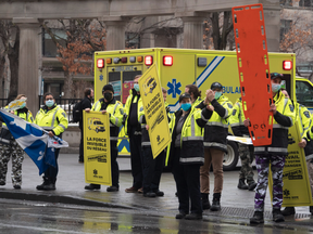 Paramedics and first responders protest against lagging contract talks in front of the premier’s office on March 31, 2022, in Montreal.