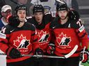 Canada's Cole Sillinger, left, celebrates with Matt Barzal, centre, and  Canadiens' Josh Anderson during the IIHF Ice Hockey World Championships semifinal match against Czechia in Tampere, Finland, on Saturday, May 28, 2022. 