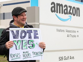 An Amazon Labour Union organizer greets workers as they begin voting to unionize a second warehouse in the Staten Island borough of New York City on April 25, 2022.