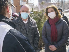 Quebec Health Minister Christian Dubé and local MNA Paule Robitaille chat with a community worker March 29, 2021.