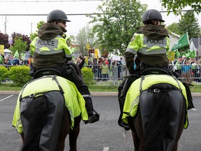 Surete du Quebec mounted police officers guard the grounds of the convention centre as Coalition Avenir Quebec hold its annual congress, in Drummondville, Que., Saturday, May 28, 2022.