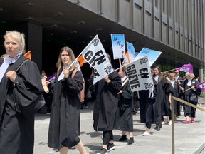 Legal aid lawyers hold a half-day strike as their contract negotiations are in a stalemate, in Montreal on Tuesday, May 24, 2022.