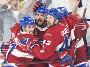Rocket's Cedric Paquette, middle, celebrates with teammates last Thursday after a goal. Paquette scored the game-tying goal late in regulation Tuesday night, which led to Laval's OT win.