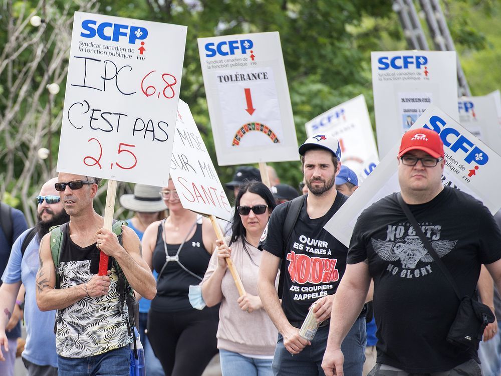 Croupiers take part in a march to the casino in Montreal on Saturday, May 21, 2022, where they launched an unlimited general strike.