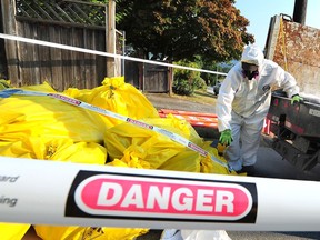A worker removes hazardous waste. 