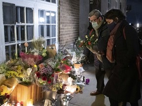 Régis Labeaume, then mayor of Quebec City, brings flowers at a vigil to honour Suzanne Clermont, who was stabbed to death on Oct. 31, 2020.