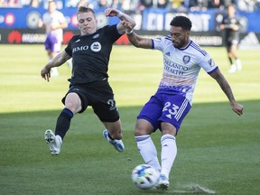 CF Montéeal's Alistair Johnston (22) challenges Orlando City's Jake Mulraney during second half MLS soccer action in Montreal on Saturday, May 7, 2022.