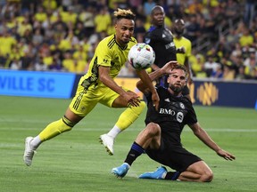 Nashville SC midfielder Hany Mukhtar (10) tries to play the ball as it is hit away by CF Montreal defender Rudy Camacho (4) during the second half at GEODIS Park.