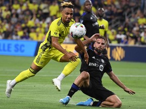 Nashville SC midfielder Hany Mukhtar (10) tries to play the ball as it is hit away by CF Montréal defender Rudy Camacho (4) at GEODIS Park in Nashville on May 18, 2022. CFM had their eight-game unbeaten streak snapped with the 2-1 road loss at Nashville SC.