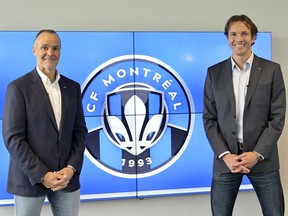 CF Montréal chairman Joey Saputo, left, and team president Gabriel Gervais with the new club logo to be used in the 2023 season during a news conference in Montreal on May 27, 2022.