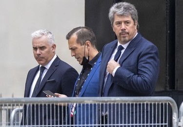 Former Montreal Canadiens head coach Dominique Ducharme, left, and former vice-president of public affairs and communications Paul Wilson. right, leave after the funeral for Guy Lafleur at Mary Queen of the World Cathedral in Montreal Tuesday May 3, 2022.