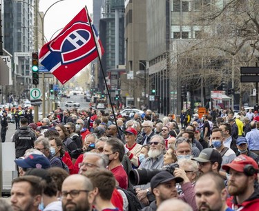 Fans fill the intersection of René-Lévesque Blvd. and Metcalfe St. for the funeral for Guy Lafleur at Mary Queen of the World Cathedral in Montreal Monday May 2, 2022.