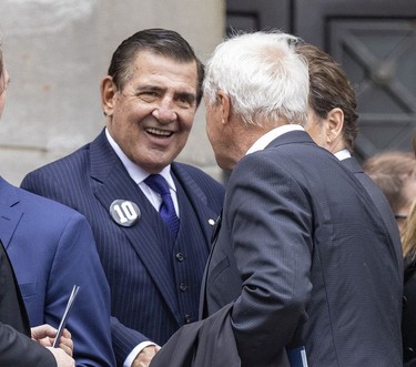 Former Montreal Canadiens player and general manager Serge Savard, left, greets former Toronto Maple Leaf Darryl Sittler following the funeral for Guy Lafleur at Mary Queen of the World Cathedral in Montreal Tuesday, May 3, 2022.