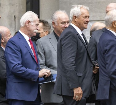 Former NHL players Lanny McDonald,left, Gilbert Perrault and Darryl Sittler leave after the funeral for Guy Lafleur at Mary Queen of the World Cathedral in Montreal Tuesday, May 3, 2022.
