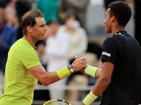 Montreal's Félix Auger-Aliassime and Spain's Rafael Nadal shake hands after their fourth round match on Sunday, May 29, 2022, at the French Open in Paris.