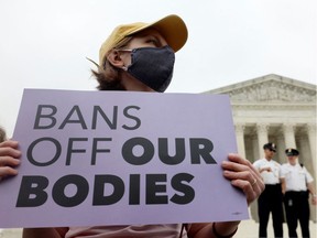 A demonstrator holds a sign during a protest outside the U.S. Supreme Court, after the leak of a draft majority opinion written by Justice Samuel Alito preparing for a majority of the court to overturn the landmark Roe v. Wade abortion rights decision later this year, in Washington on May 3, 2022.