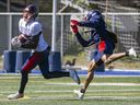 Receiver Fabian Guerra catches a touchdown pass behind a defender during Montreal Alouettes training camp in Trois-Rivières on May 25, 2022.