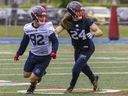 Safety Marc-Antoine Dequoy, right, covers receiver Mathieu Robitaille during the Montreal Alouettes training camp in Trois-Rivières on May 26, 2022.