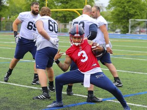 Quartrback Vernon Adams posed for a photographer in front of a group of offensive linemen during Alouettes training camp last week.