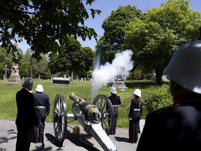 The Westmount Battery fires a refurbished cannon dating from 1810 to salute Queen Elizabeth's Platinum Jubilee on the grounds of the Mount Royal Cemetery in Montreal, on Saturday, June 4, 2022.