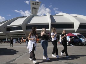 MONTREAL, QUE.: JUNE 3, 2022 --  People walk along the esplanade at the Olympic Stadium  for the first of Les Premiers Vendredis on Friday June 3, 2022.