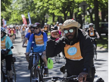 A man gestures as he and others leave the Lafontaine Park area for the Tour de l'Île in Montreal on Sunday, June 5, 2022.