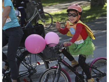 A youngster and others leave the Lafontaine Park area for the Tour de l'Île in Montreal on Sunday, June 5, 2022.