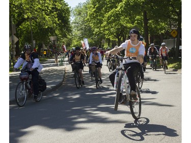 A young man and others leave the Lafontaine Park area for the Tour de l'Île in Montreal on Sunday, June 5, 2022.