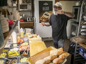 Cantor Bakery owner Joseph Cohen, talks to customer from behind the food counter on Tuesday June 7, 2022. The bakery is closing at the end of the month.