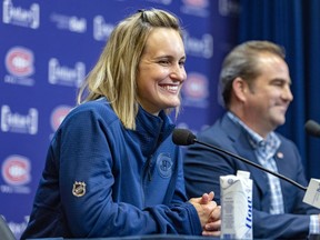 Marie-Philip Poulin was all smiles during a news conference with Canadiens president Geoff Molson on Tuesday. Poulin is confident she can balance her playing career and training for another Olympics with her new job with Montreal, which will involve working with the team's young prospects.