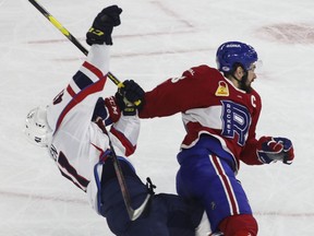 Xavier Ouellet of the Laval Rocket and Will Bitten of the Springfield Thunderbirds get tangled up in the third period of their AHL playoff series at Place Bell in Laval on June 8, 2022.