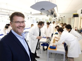 Martin Braun, principal of Alexander Von Humboldt School, with the Grade 11 chemistry class in Baie-D'Urfé on Tuesday.