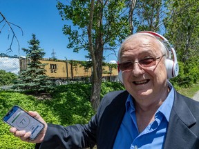 Beaconsfield sound wall advocate Michel Rheault with a decimal reading app on his iPhone near Highway 20.