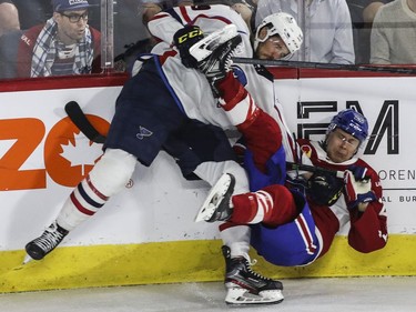 Jesse Ylönen of the Laval Rocket is sent flying by Mackenzie MacEachern  of the Springfield Thunderbirds in the third period in Game 5 of the teams' Calder Cup Eastern Conference AHL final at Place Bell in Laval on Saturday, June 11, 2022.