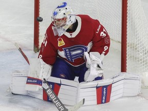 The puck flies past Laval Rocket goalie Cayden Primeau in the third period against the Springfield Thunderbirds in Game 5 of the teams' Calder Cup Eastern Conference AHL final at Place Bell in Laval on June 11, 2022.