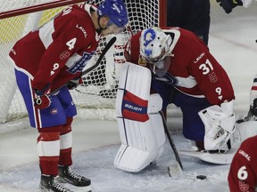 Goalie Cayden Primeau of the Laval Rocket shows his dejection along with  defenceman Tobie Paquette-Bisson after James Neal of the Springfield Thunderbirds scored in overtime in Game 5 of the teams' Calder Cup Eastern Conference AHL final at Place Bell in Laval on Saturday, June 11, 2022.