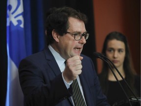 Bernard Drainville announces his decision to leave politics and take up a radio career in 2016. His daughter Rosalie looks on.